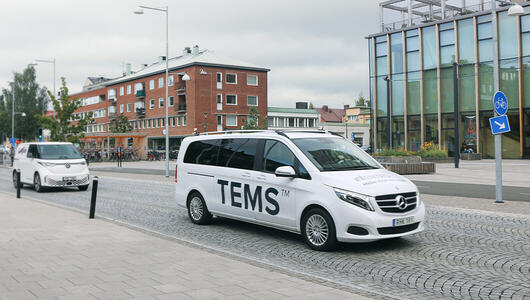 TEMS van driving in the city equipped with TEMS Sense for automated network performance monitoring.