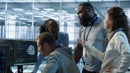 Engineering team collaborating around network and service data dashboards to enhance network intelligence.