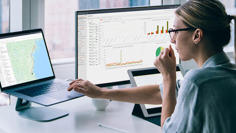 Woman looking at reports from TEMS Cloud, Infovista's real-time control and analytics solution