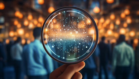 Hand holding magnifying glass, for holistic observability