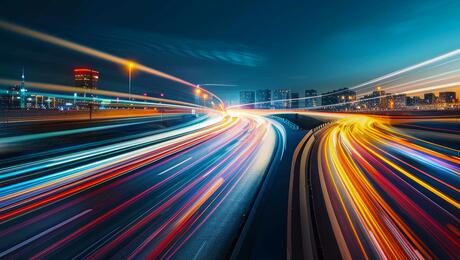 Blurred traffic background banner at night, symbolizing drive testing in a real-world urban environment