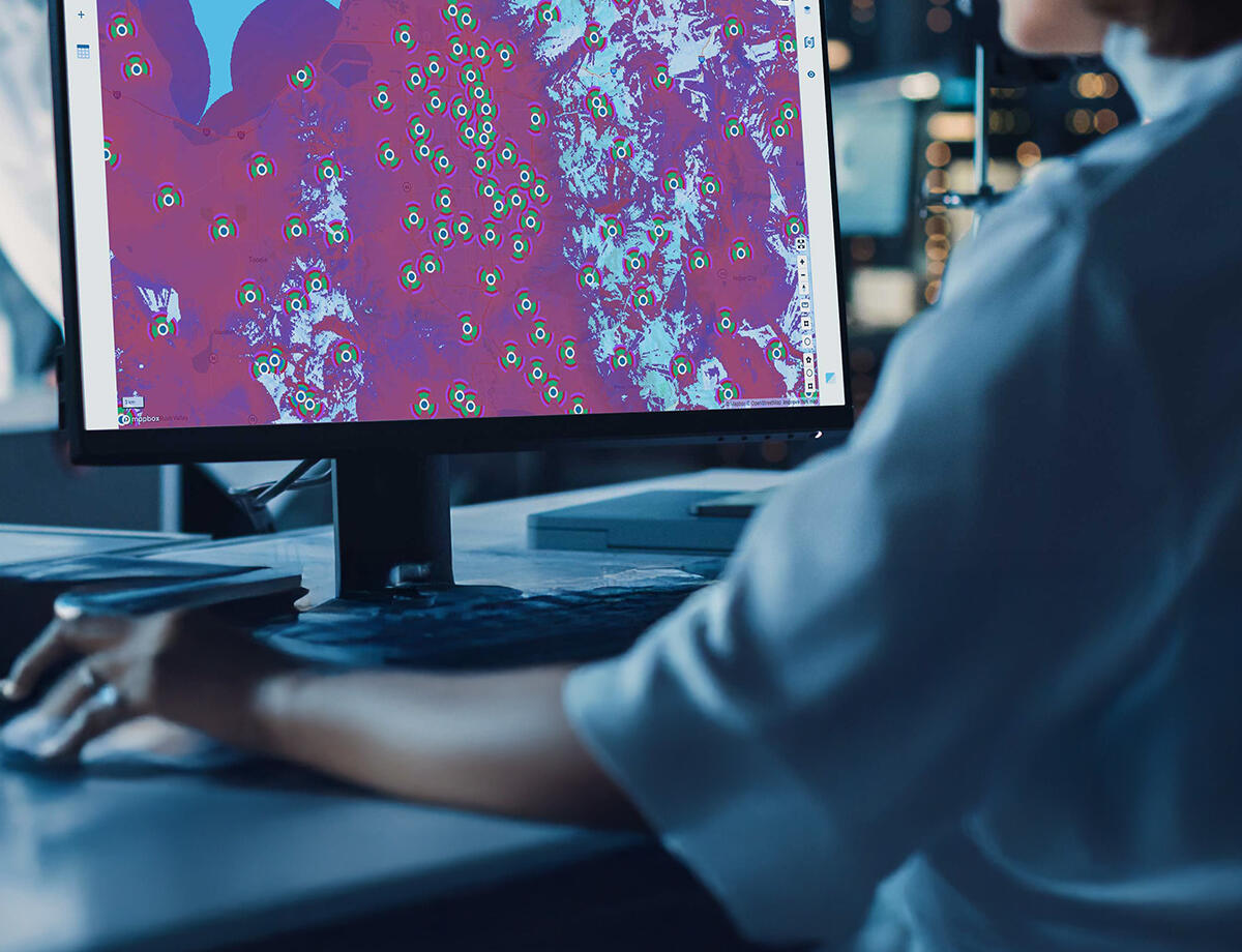 Woman in office looking at Infovista's Planet planning capabilities