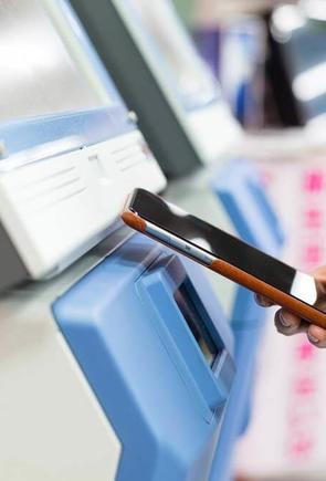 Woman using mobile phone for paying on ticketing