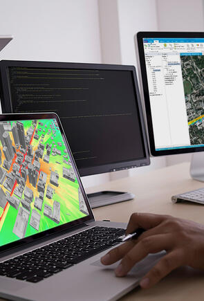 Person sitting in front of two monitors with Planet software