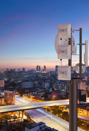 5G tower with a dark city background