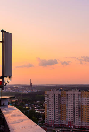 Cell tower on rooftop in urban city