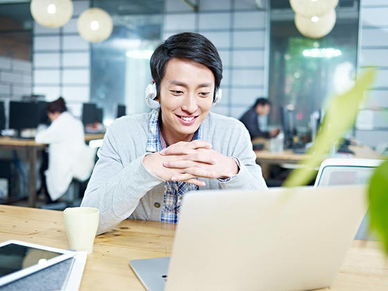 Asian guy looking at screen